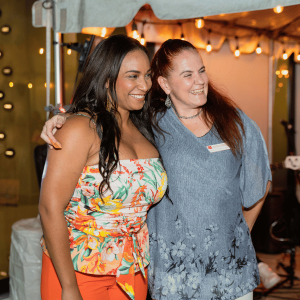 two women smiling - holiday party